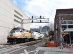 A mid afternoon northbound Sunrail Train approaches LYNX Central Station with MP32PH-Q # 108 as power as some of the Orlando skyline buildings stand in the background